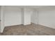 Neutral carpeted bedroom with white trim and walls featuring a closed closet and open doorway at 2996 Grand Ridge Dr, Greenwood, IN 46143