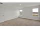 Well-lit bedroom with neutral walls and flooring; abundant natural light from dual windows at 2996 Grand Ridge Dr, Greenwood, IN 46143