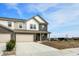 New construction townhome featuring a brick facade, white trim, and attached two-car garage at 2996 Grand Ridge Dr, Greenwood, IN 46143