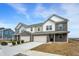 View of townhomes with brick and siding, a two-car garage, and completed sidewalks at 2996 Grand Ridge Dr, Greenwood, IN 46143
