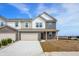 Beautiful townhome with a brick facade, two-car garage, and a well-lit driveway at 2996 Grand Ridge Dr, Greenwood, IN 46143