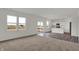 Bright living room area with large windows and an open concept kitchen space at 2996 Grand Ridge Dr, Greenwood, IN 46143