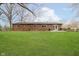 A home with a vast, grassy backyard bordered by a wooden fence and mature trees, great for outdoor gatherings at 3549 Woodale Rd, Indianapolis, IN 46234