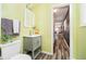 Well-lit bathroom with stylish vanity, modern fixtures, and access to the hallway at 3549 Woodale Rd, Indianapolis, IN 46234
