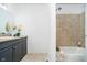 This cozy bathroom features a shower-tub combo with neutral tiling, and a single sink vanity at 3549 Woodale Rd, Indianapolis, IN 46234