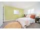 Comfortable bedroom with carpet, a cozy bed, two windows and a straw decorative rug at 3549 Woodale Rd, Indianapolis, IN 46234