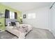 Cozy bedroom featuring a plush bed, carpet, modern decor, and ample natural light from the window at 3549 Woodale Rd, Indianapolis, IN 46234