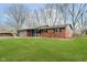 Well maintained brick home on a manicured lawn with mature trees at 3549 Woodale Rd, Indianapolis, IN 46234