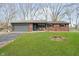 Charming brick ranch-style home featuring a lush front lawn and attached two-car garage at 3549 Woodale Rd, Indianapolis, IN 46234