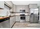 Well-lit kitchen features gray cabinets, stainless steel appliances, wood countertops, and subway tile backsplash at 3549 Woodale Rd, Indianapolis, IN 46234
