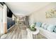 Bright living room with views into dining area, wood floors, comfortable sofa, and stylish decor at 3549 Woodale Rd, Indianapolis, IN 46234
