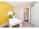 The office area showcases a white desk, contemporary lighting, and convenient closet storage at 3549 Woodale Rd, Indianapolis, IN 46234