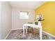 Bright office space features a white desk, neutral walls, and a cheerful yellow accent wall at 3549 Woodale Rd, Indianapolis, IN 46234