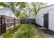 Backyard with a wooden fence and a grassy walking path at 3944 Strathmore Dr, Indianapolis, IN 46235