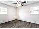 This bedroom features a ceiling fan, two windows providing natural light, and laminate floors at 3944 Strathmore Dr, Indianapolis, IN 46235