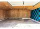 Open garage with concrete floors and plywood walls at 3944 Strathmore Dr, Indianapolis, IN 46235