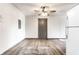 Open-concept living room featuring neutral walls, modern flooring, and nearby refrigerator at 3944 Strathmore Dr, Indianapolis, IN 46235