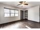Inviting living room with vinyl floors, a ceiling fan, and built-in shelving at 3944 Strathmore Dr, Indianapolis, IN 46235