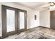 Open living room with double door access to backyard and modern, neutral finishes at 3944 Strathmore Dr, Indianapolis, IN 46235