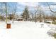 This backyard features a snow covered lawn and a view of neighborhood homes at 401 W Westfield Blvd, Indianapolis, IN 46208