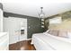Comfortable bedroom featuring a decorative mural wall, wooden floors, a large closet, and natural light at 401 W Westfield Blvd, Indianapolis, IN 46208