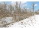 This lot features a creek with snow covered banks and a tree line at 401 W Westfield Blvd, Indianapolis, IN 46208