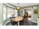 Cozy dining area by bay window with an open view into the living room featuring a warm interior design at 401 W Westfield Blvd, Indianapolis, IN 46208