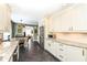 Spacious kitchen with stainless steel appliances, white cabinets, and granite counters open to the dining area at 401 W Westfield Blvd, Indianapolis, IN 46208