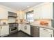 Updated kitchen featuring stainless steel appliances, sleek countertops, and bright lighting for a modern design at 401 W Westfield Blvd, Indianapolis, IN 46208