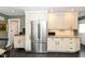 Bright modern kitchen featuring stainless steel appliances, white cabinets, and an open dining and entertaining space at 401 W Westfield Blvd, Indianapolis, IN 46208
