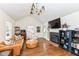 Spacious living room featuring hardwood floors, fireplace, comfortable leather couch and modern light fixture at 401 W Westfield Blvd, Indianapolis, IN 46208