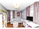 This office features hardwood floors, a grey couch, natural light, and a desk with chair at 401 W Westfield Blvd, Indianapolis, IN 46208