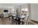 A dining area with a dark wood table, bench seating, and large windows providing lots of natural light at 4040 Jacoby Pl, Indianapolis, IN 46268