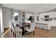 An open-concept dining area with views into the kitchen, featuring a stylish table and ample seating at 4040 Jacoby Pl, Indianapolis, IN 46268