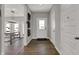 Inviting hallway with wood flooring, white doors, and decorative wall art leading to living area at 4040 Jacoby Pl, Indianapolis, IN 46268