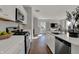 Bright kitchen with stainless steel appliances, white cabinets, a kitchen island, and hardwood floors at 4040 Jacoby Pl, Indianapolis, IN 46268