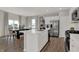 An open kitchen and dining area with white cabinets, stainless steel appliances, and stylish wood flooring at 4040 Jacoby Pl, Indianapolis, IN 46268