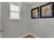 A simple laundry room with neutral walls, utility hookups, and a window for natural light at 4040 Jacoby Pl, Indianapolis, IN 46268
