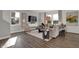 Bright living room with large windows, wood flooring, comfortable seating, and stylish decor at 4040 Jacoby Pl, Indianapolis, IN 46268