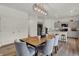 Open concept dining room features modern light fixture, hardwood floors, and is open to the kitchen at 4046 Jacoby Pl, Indianapolis, IN 46268