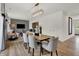Open concept dining room features modern light fixture, hardwood floors, and is open to the living room at 4046 Jacoby Pl, Indianapolis, IN 46268