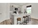 Modern kitchen featuring light gray cabinets, an island with bar seating, and sleek appliances at 4046 Jacoby Pl, Indianapolis, IN 46268