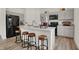 Modern kitchen boasts white quartz countertops, stainless steel appliances, gray cabinetry, and wooden bar stools at 4046 Jacoby Pl, Indianapolis, IN 46268