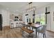 Living room and open kitchen/dining room combo features a modern light fixture and hardwood floors at 4046 Jacoby Pl, Indianapolis, IN 46268
