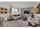 Bright and airy living room features neutral color palette, gray accent wall, and large windows at 4046 Jacoby Pl, Indianapolis, IN 46268