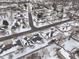 Aerial view of a quiet neighborhood showcasing snow-covered rooftops and tree-lined streets in a peaceful community at 4501 N Wheeling Ave # 10A-101, Muncie, IN 47304