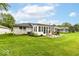 Exterior back of the house showing patio, grill, lawn, and a sunroom at 4501 N Wheeling Ave # 10A-101, Muncie, IN 47304