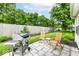 Backyard patio featuring an outdoor grill, two chairs, and landscaping at 4501 N Wheeling Ave # 10A-101, Muncie, IN 47304