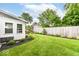 View of the backyard showing the lawn, landscaping, seating area and privacy fence at 4501 N Wheeling Ave # 10A-101, Muncie, IN 47304