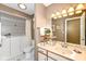 Bathroom with a soaking tub, white cabinets, and a large mirror at 4501 N Wheeling Ave # 10A-101, Muncie, IN 47304